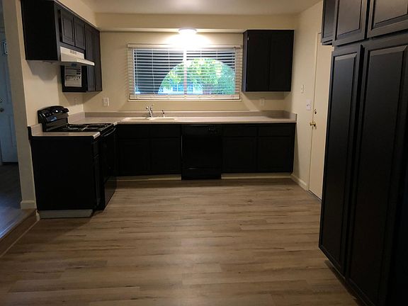 Kitchen with new GE dishwasher and GE stove