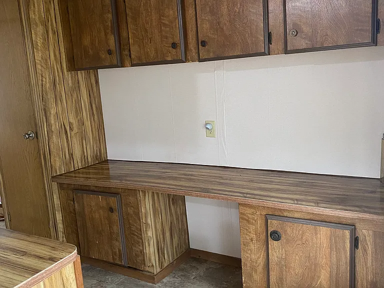 Large additional cabinets and counter space/breakfast nook in the kitchen, pantry to the left.