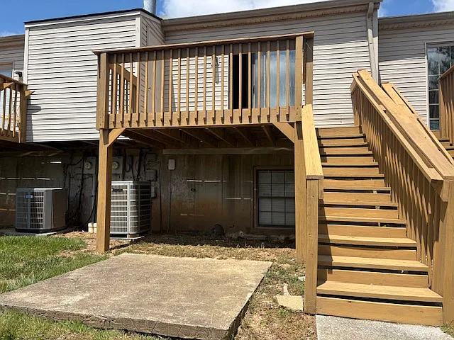 Townhouse from yard with downstairs concrete patio
