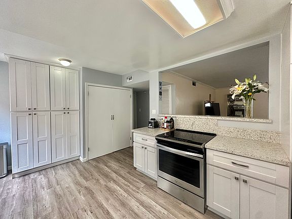 Open concept floor plan into living room w/ full sized washer/dryer in laundry closet *Whirpool