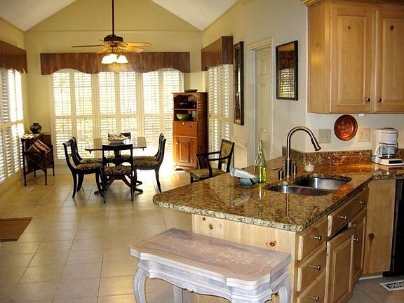 The breakfast dining area is surrounded by windows for a great backyard view. 