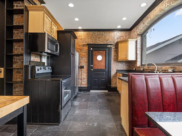 Full kitchen with built in seating.