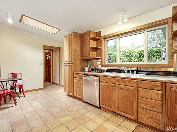 Kitchen from dining area. Window faces out to front yard.