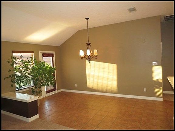 Breakfast room has tile floors and is open to family room.