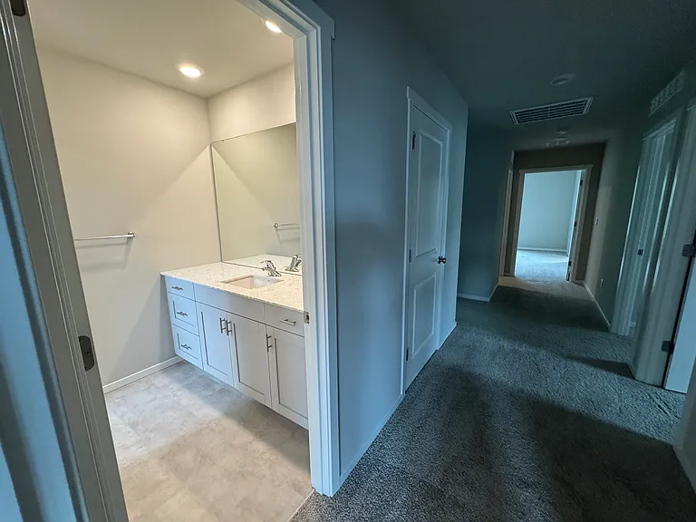 Upstairs full bathroom. Sink area leads to bath/shower and the toilet.