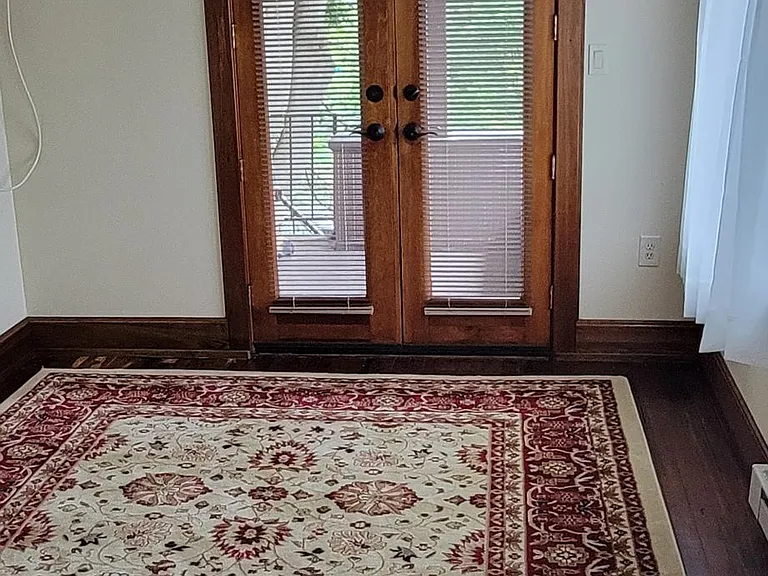 Bedroom with French doors leading to covered porch