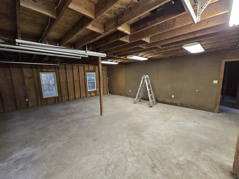 Garage/workshop front room with full pegboard wall