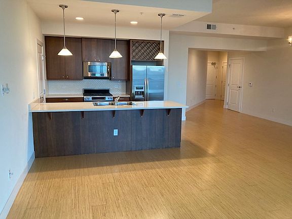 Open floorplan showing kitchen, entry way and guest bathroom