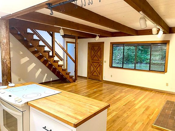 View from the kitchen. BR#2 is at the base of the stairwell. The Dutch door leads to the covered back porch & private yard. To the photographer's back is the door that leads to the laundry & storage area. Washer & Dryer included.