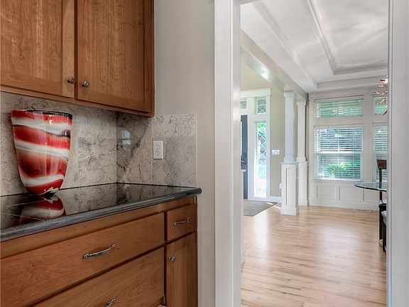 Butler pantry with Viking warming drawer, granite tile counter and backsplash, cabinets and drawers.