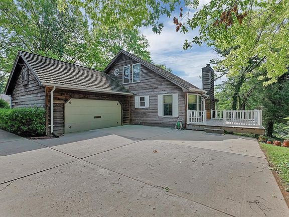 Rear view of home showing garage & newer deck.