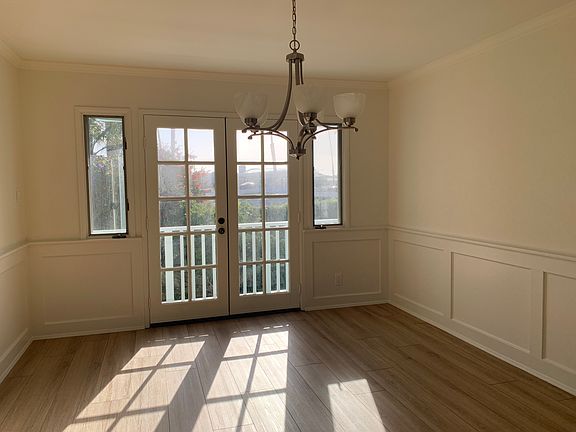 Dining room with French doors that open to a small balcony with a peekaboo view of Marina Park.