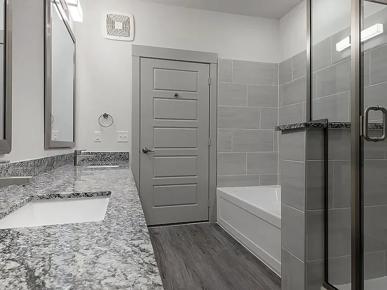 Spa-Inspired Bathroom With Granite Countertops and Dual Bath Options