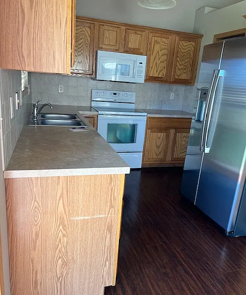 Kitchen with new refrigerator, microwave, stove and dishwasher