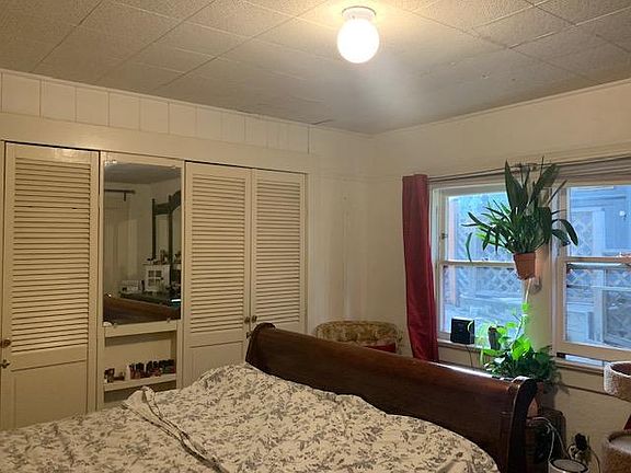 Sleigh bed and walk-in closets in master bedroom