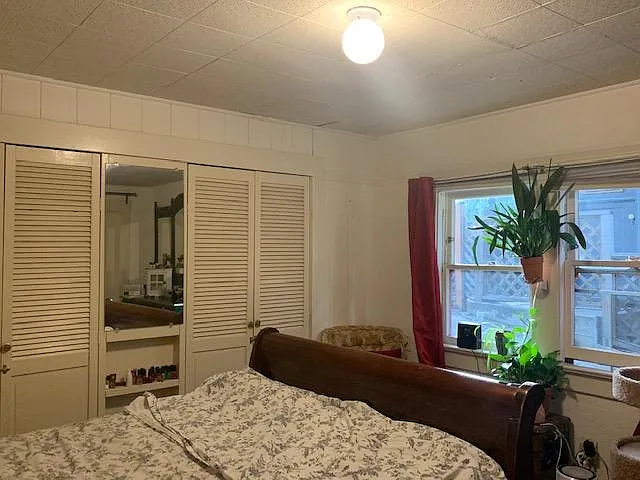 Sleigh bed and walk-in closets in master bedroom
