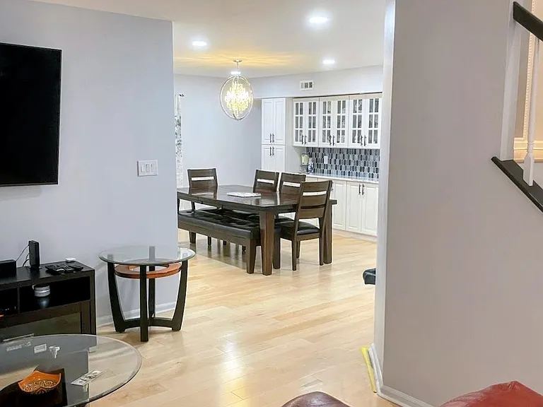 The left side of entrance is another cozy seating area that flows into the dining area, perfect for entertaining guests and enjoying meals together.