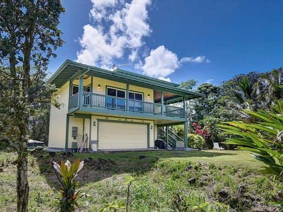 View of wrap around lanai of house and double patio doors of main floor
