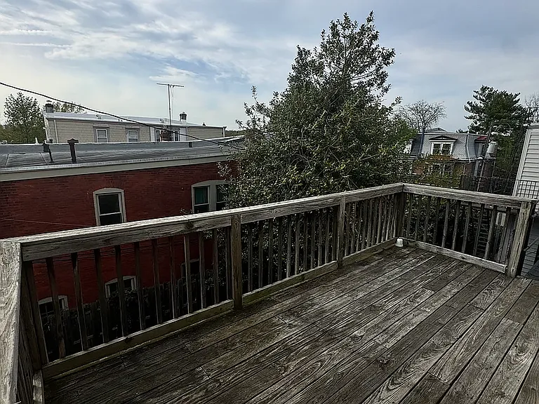 spacious deck overlooking the yard with a fire escape staircase