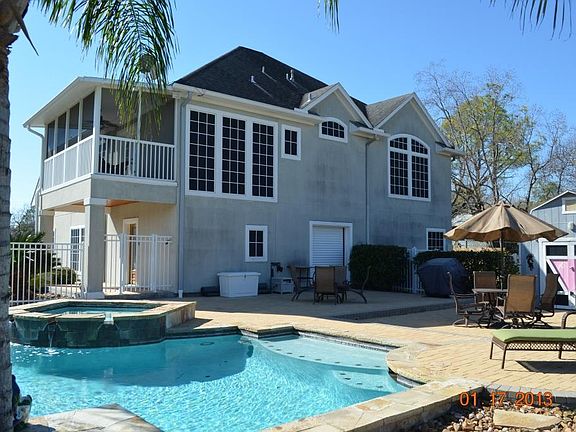 This is a rear view of the home and patio area. There is a roll up door that opens into the garage/g