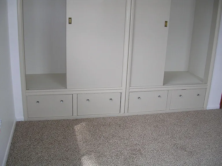 Master Bedroom Built-In Closet with Space Saving Drawers and Storage Both Above and Below.