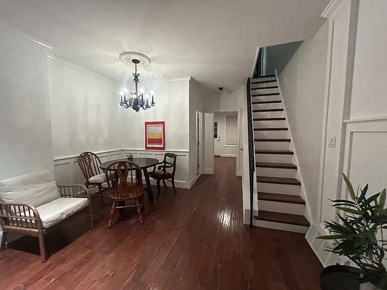 first floor living room leading to 1/2 bath and kitchen
