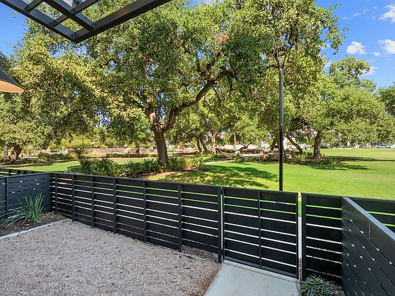 Front yard opens to park! The view of the park can be seen from the main living area and the primary bedroom.