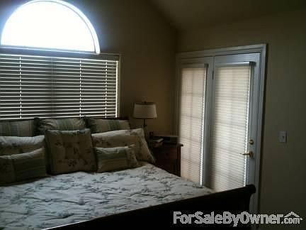 Master bed with french doors to patio. : Vaulted ceiling with ceiling fan.