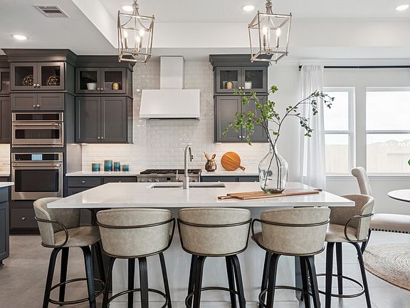 Kitchen with stacked glass-front upper cabinets