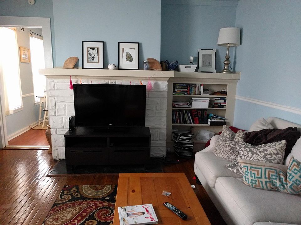Living room w Built-ins / fireplace is for looks only / blinds and curtains included / hardwood floor