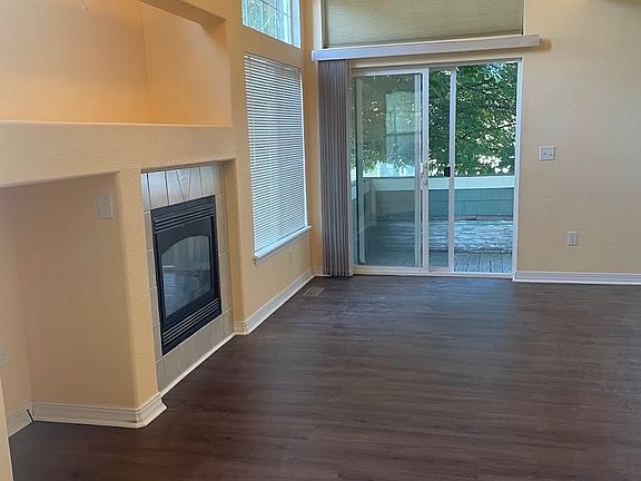 The living room has an electronics nook, gas fireplace, large mantle area, and wiring for a sound system.