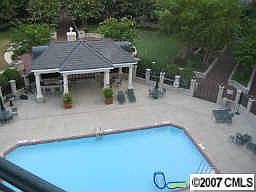 View of patio and pool from balcony