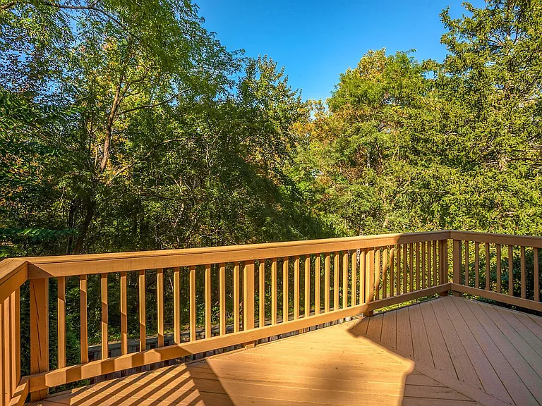 Deck off the living room on main floor overlooks woods. Full privacy.