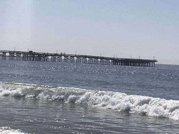 Stroll the sandy beach as the waves roll in