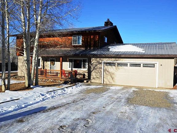 Mature trees and landscaping, gravel parking area, fronting Fairway Lane