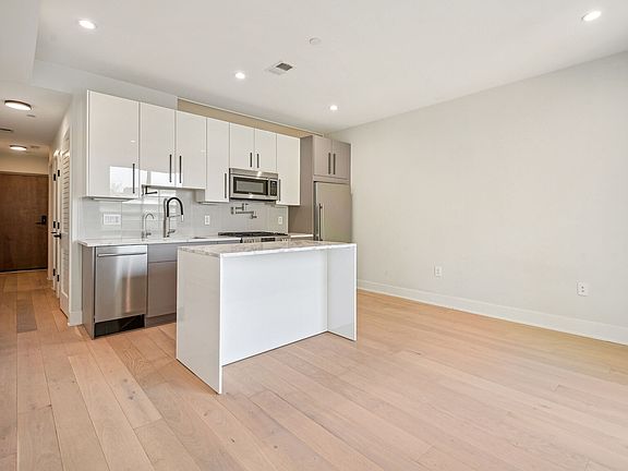 Large kitchen, eating, dining and living area. Hallway with washer/dryer.