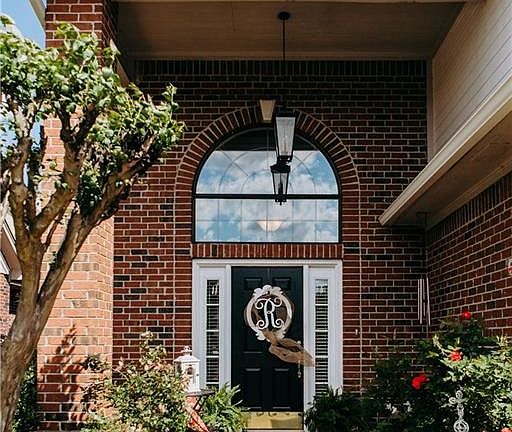 Front Porch - End unit in the back of this upscale townhome community offers additional privacy*Home was originally on the 1996 Parade of Homes so extra custom features were added!
