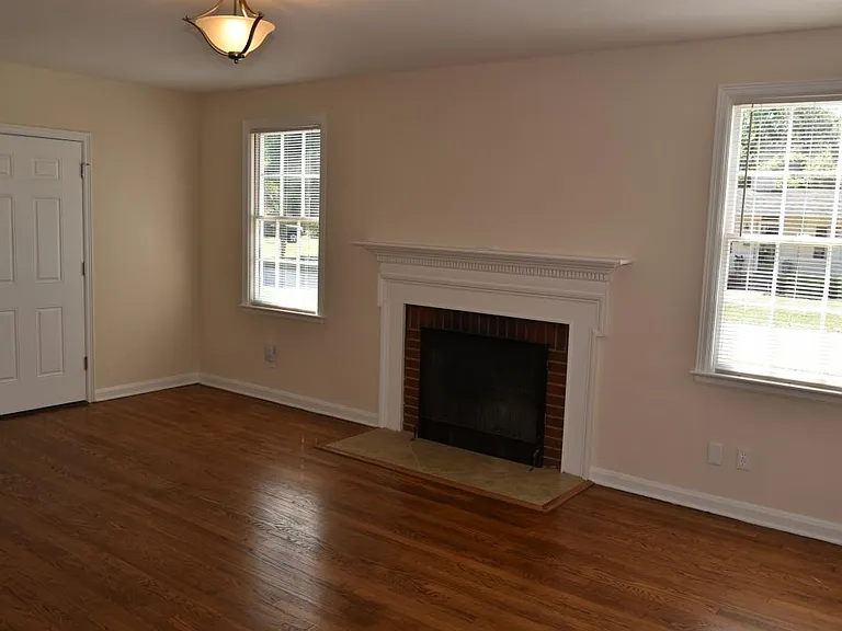 Living room: Refinished oak floors, fireplace, paneled entry door w/ deadbolt, new lighting
