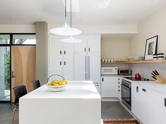 This is the kitchen as seen from the dining area. There is room to sit at the island for casual meals and morning coffee.
