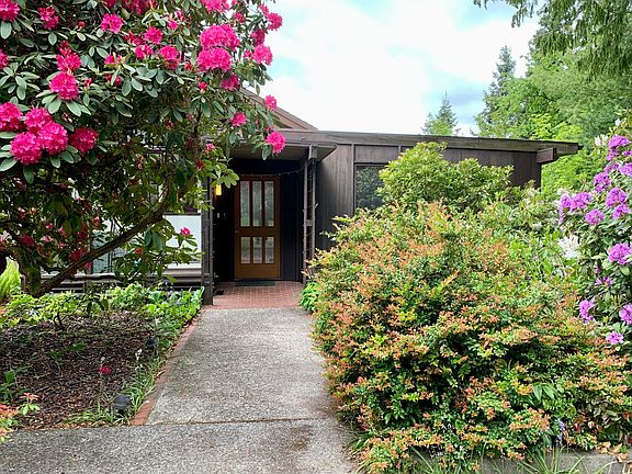 Main entry with lush gardens.