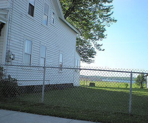 Side yard with view of firepit and river