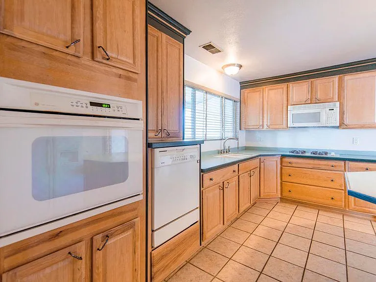 Kitchen with over the cooktop new microwave, elevated diswas