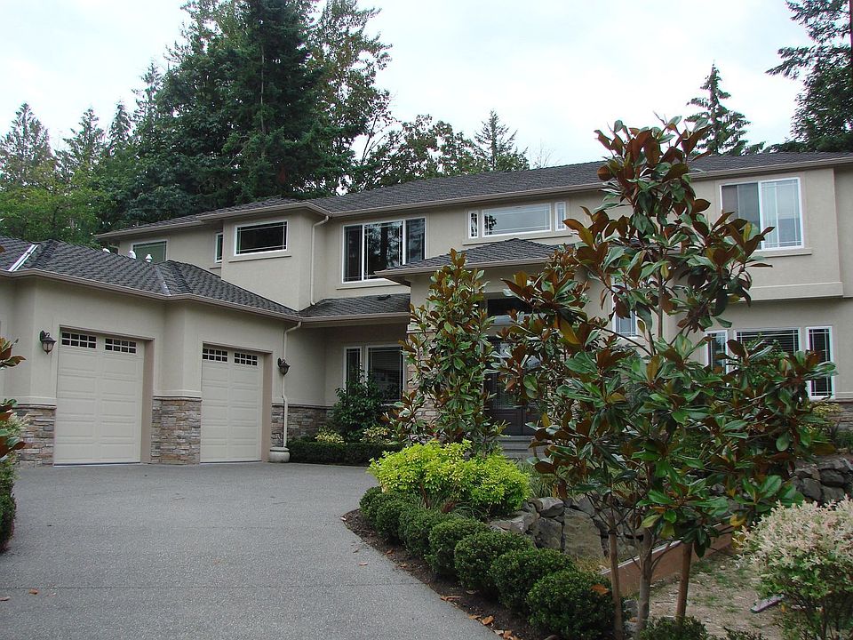 Front view of house from magnolia tree lined driveway
