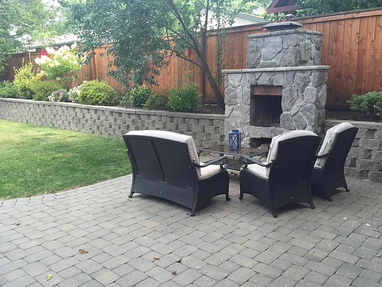 Outdoor wood burning fireplace and large paver patio