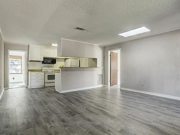 VIEW OF THE LIVING AREA WITH LUXURY VINYL PLANK FLOORING.