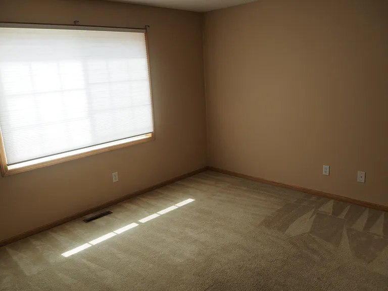 Second bedroom with large window.