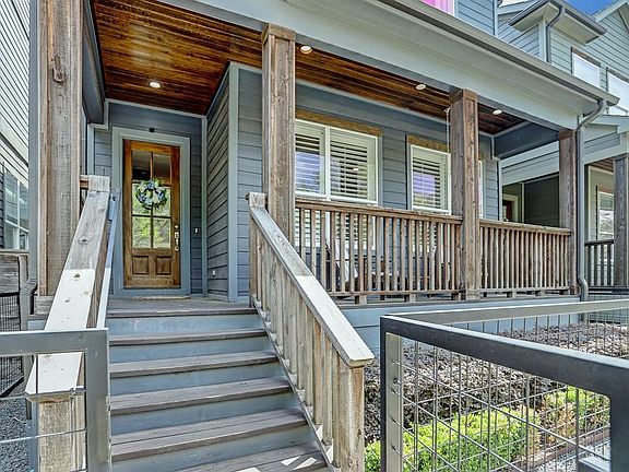 The front of the home faces Beall Street with a comfortable front porch and a private gated area.