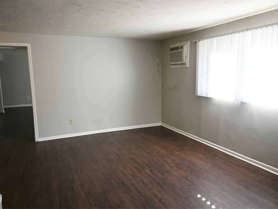 Large living room with window in a unit at Benson Crest Apartments.