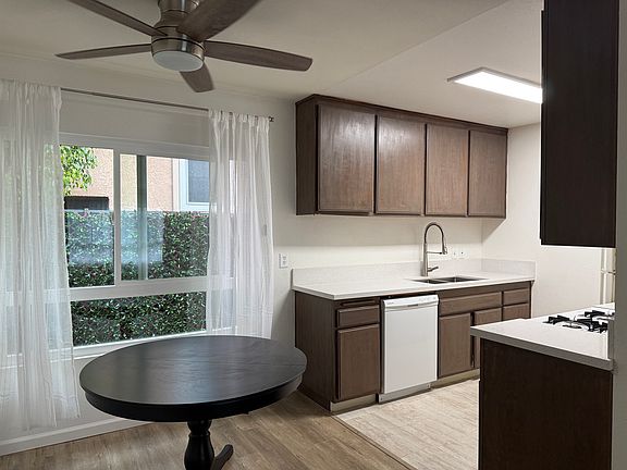 New quartz countertops, travertine travertine tile, stainless steel deep sink, commercial style kitchen faucet