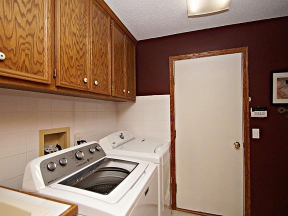 Convenient mud room filled with perks.  A hidden ironing board, new washer and dryer and a ton of storage.